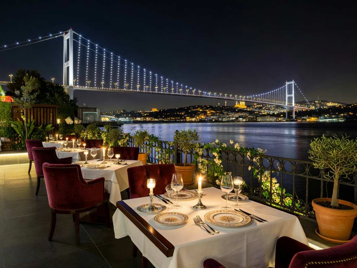 Fine dining terrace setup at Tuğra restaurant overlooking the illuminated Bosphorus bridge